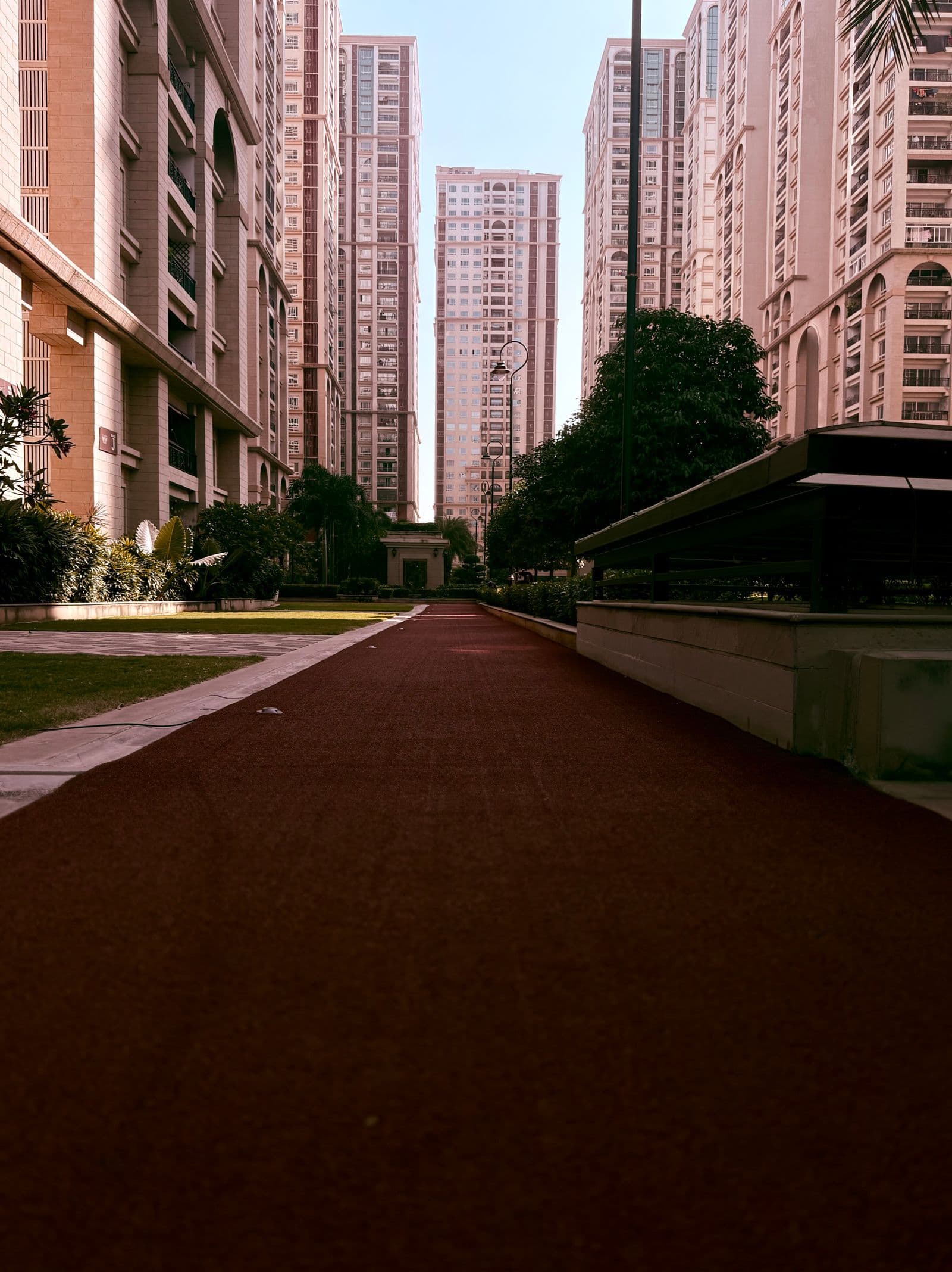 Modern residential towers above a landscaped walkway